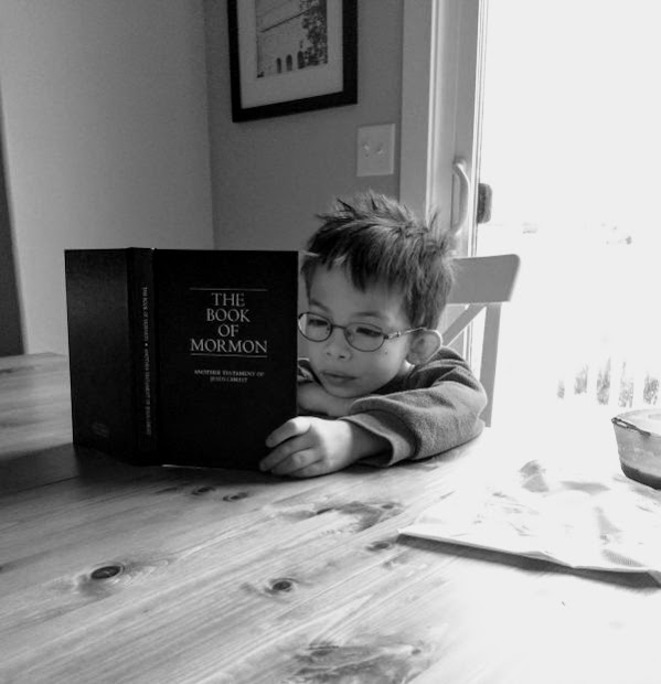 Child reading The Book of Mormon
